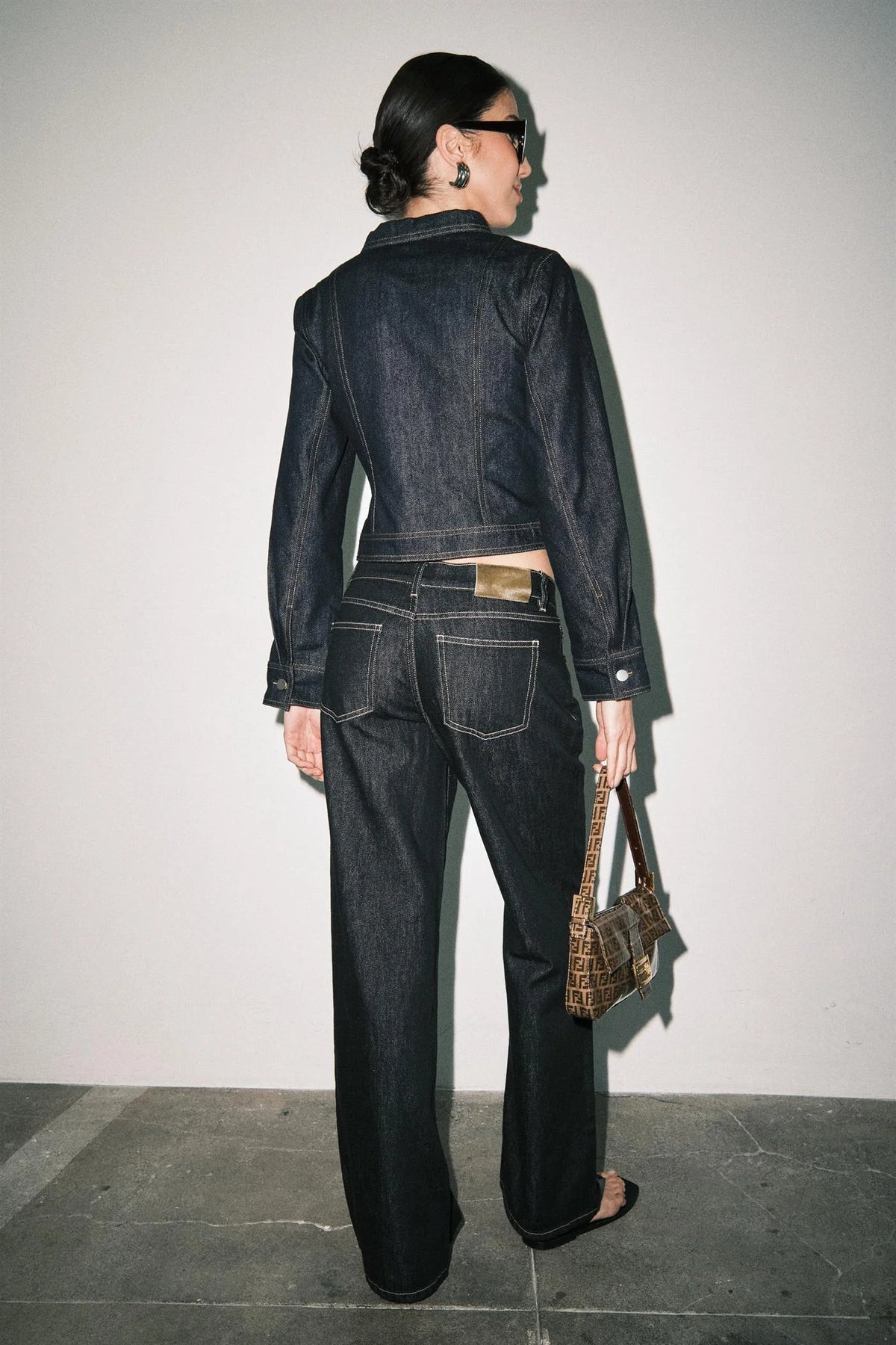 Back view of women's dark wash wide leg jeans with contrast stitching and back pockets