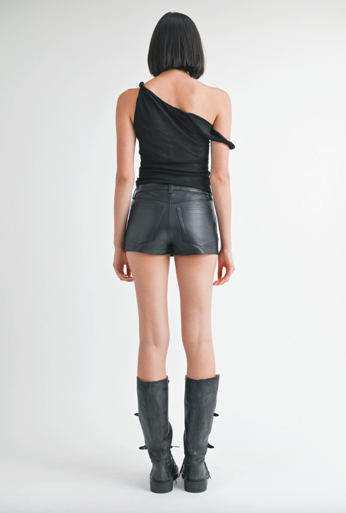Back view of women's black one shoulder mesh top highlighting the fitted silhouette and lightweight semi-sheer fabric.