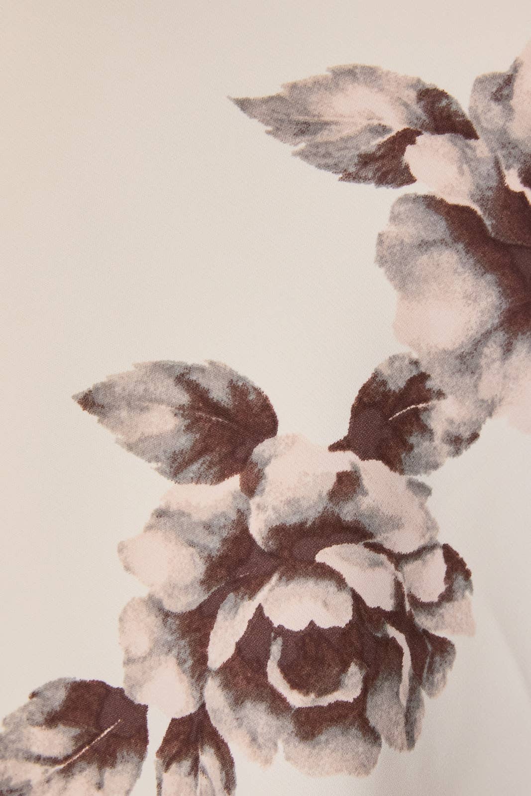 Close-up of ivory floral print and scarf detail on cropped top