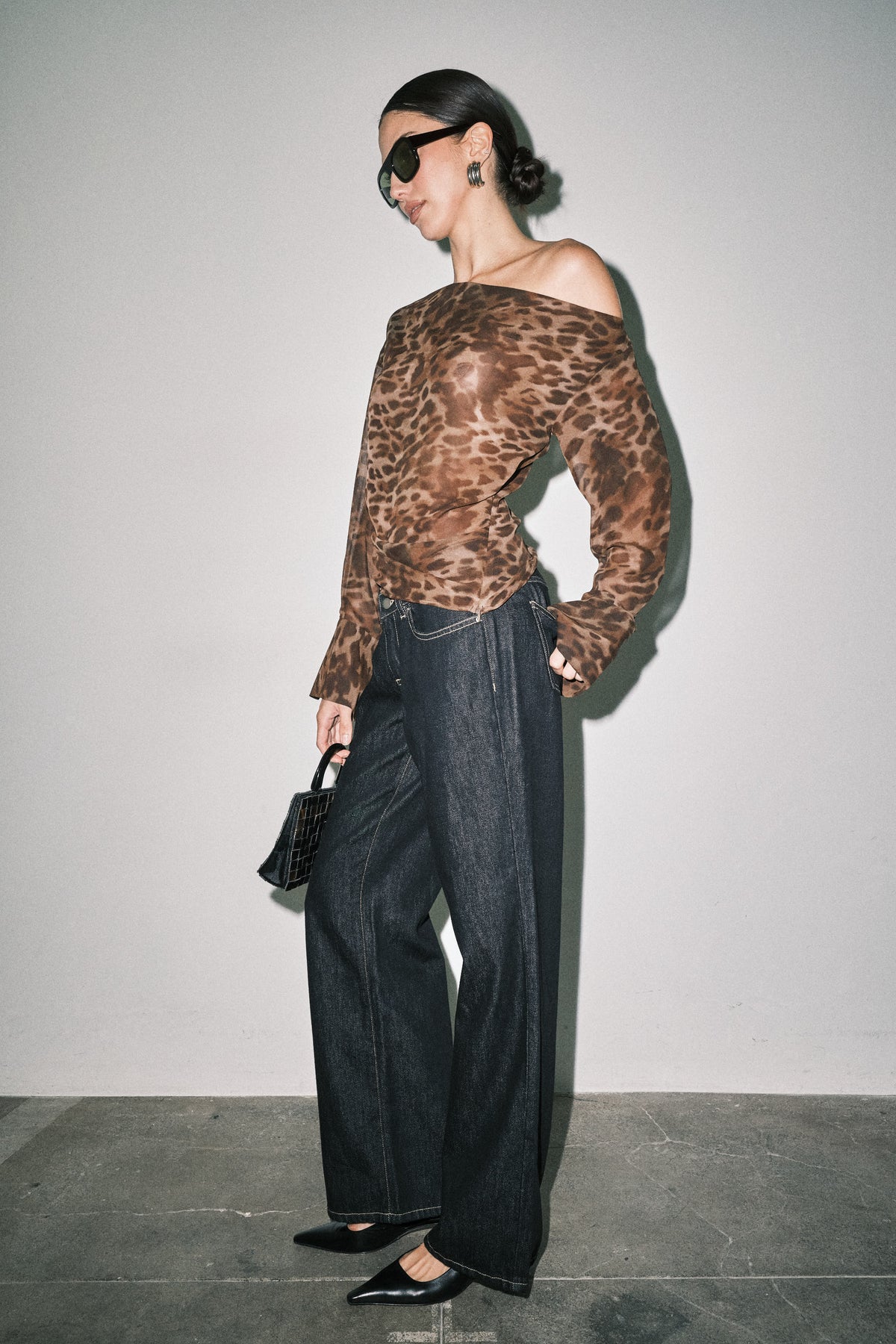 Side view of women's dark wash wide leg jeans showing relaxed silhouette