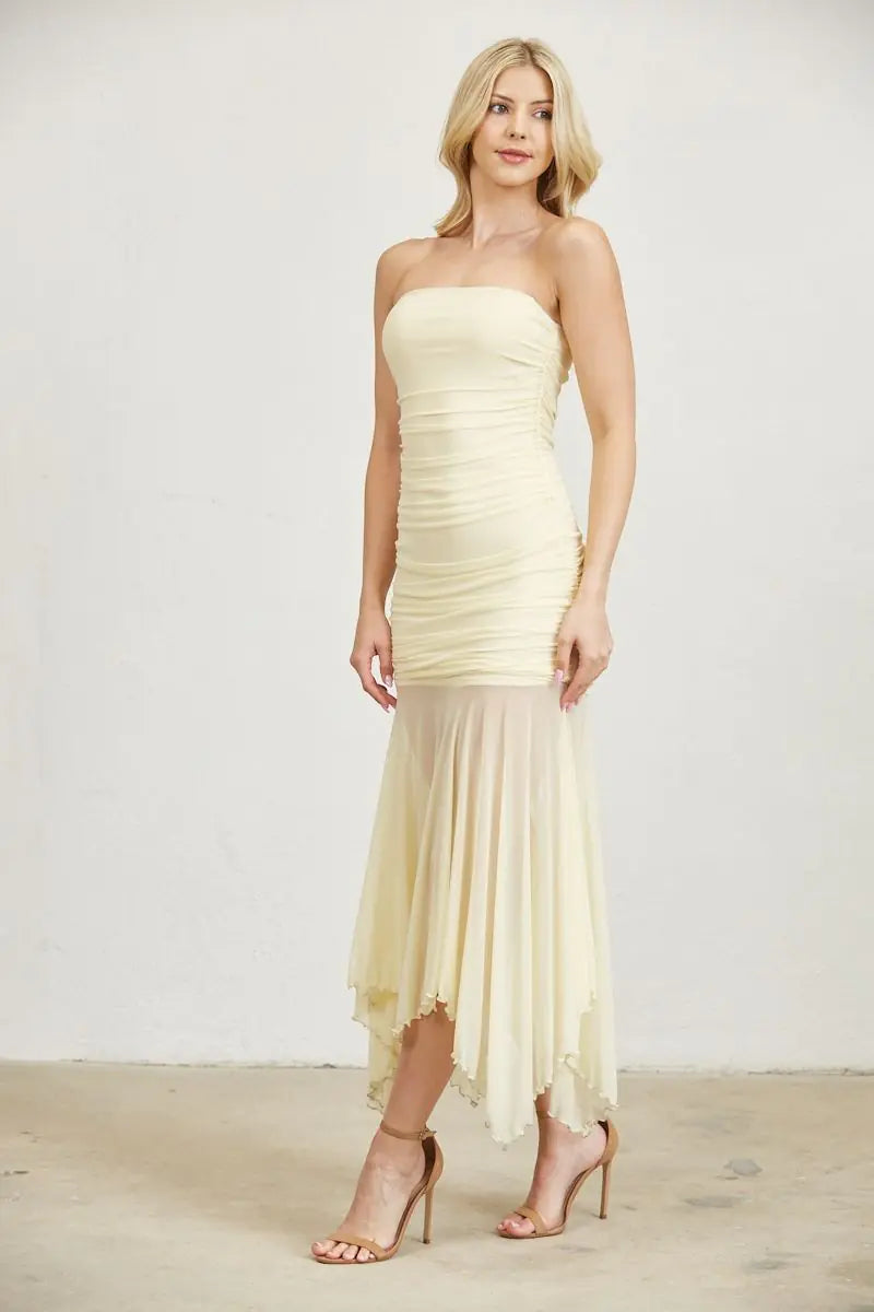 Front view of butter yellow strapless ruched maxi dress featuring a fitted bodice, straight neckline, and flowing asymmetrical mesh skirt.