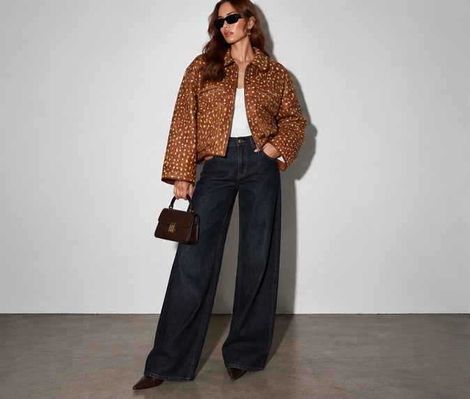 Deer print zip-up jacket in brown and cream styled with dark wash wide-leg jeans in a full-body front view