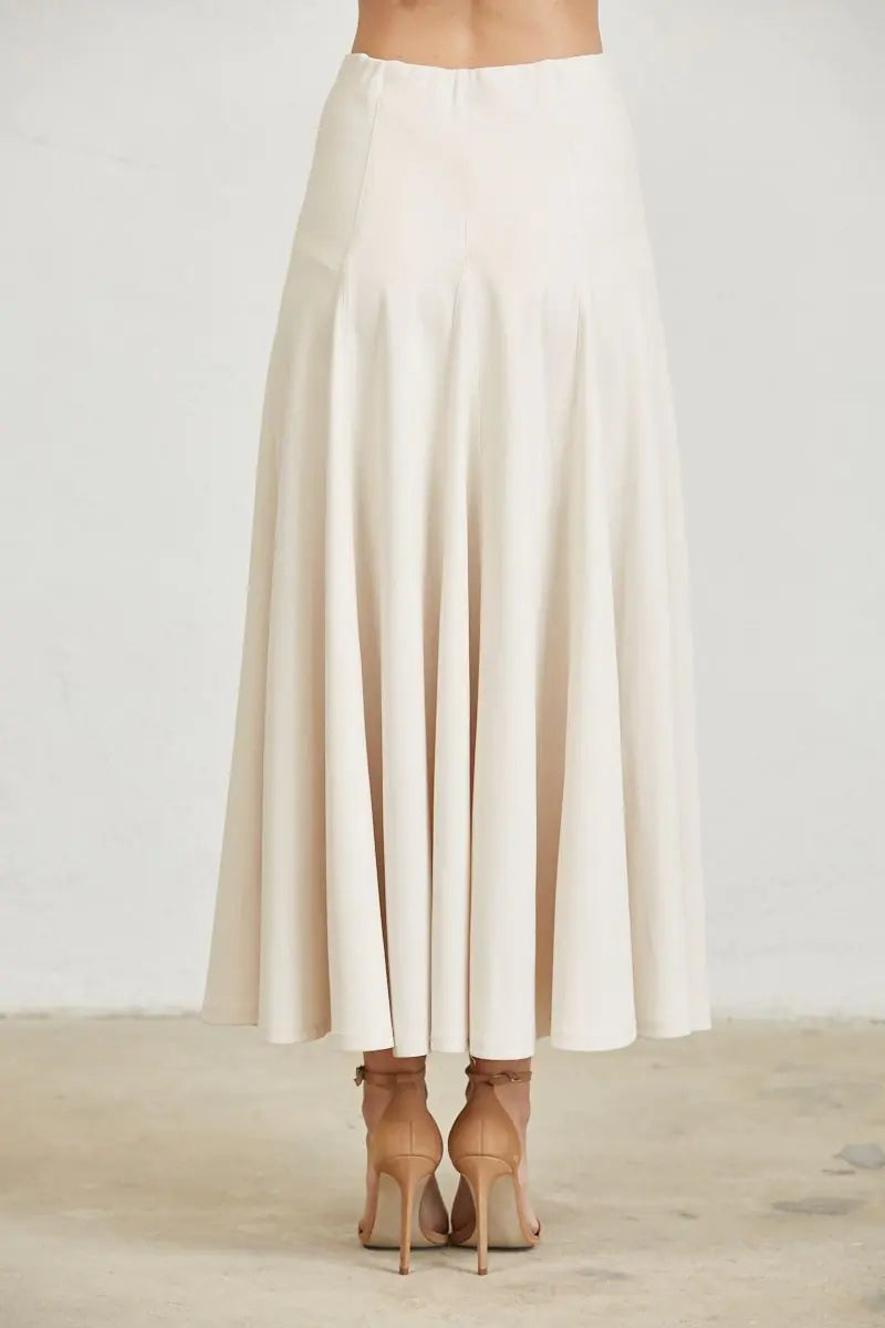 Back view of women's ivory maxi skirt showcasing the softly flared silhouette and full-length flowing design.