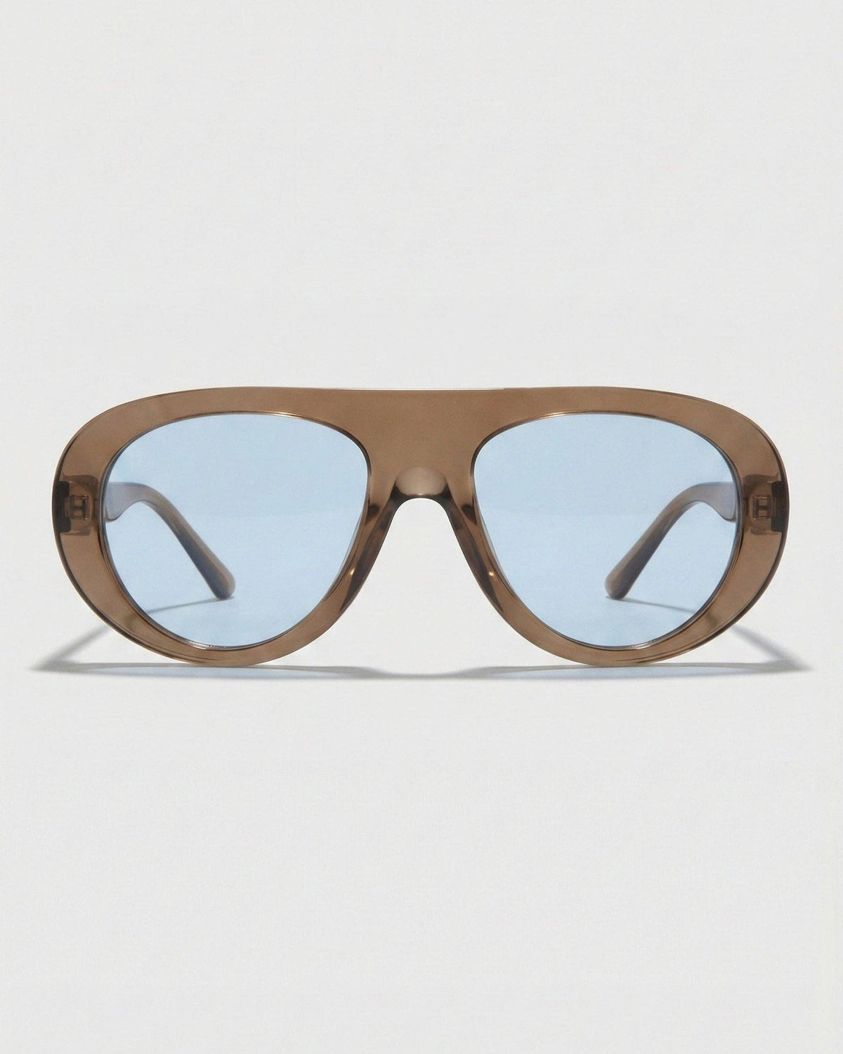 Front view of Oceane polarized aviator sunglasses featuring a bold brown frame, rounded silhouette, and blue-toned lenses.