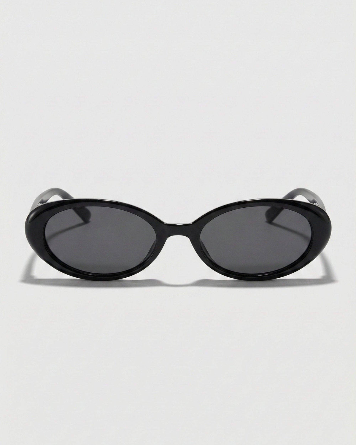 Front view of black oval polarized sunglasses featuring a narrow retro-inspired frame and dark black lenses.