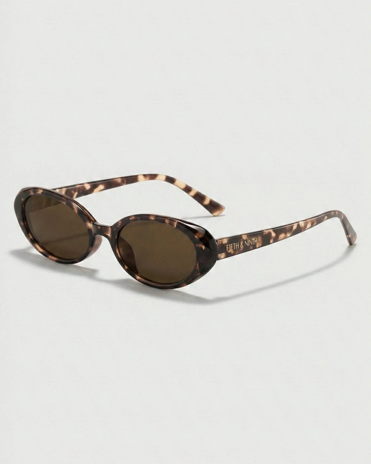 Side profile of tortoiseshell oval polarized sunglasses showcasing the slim temples, polished frame, and petite curved silhouette.