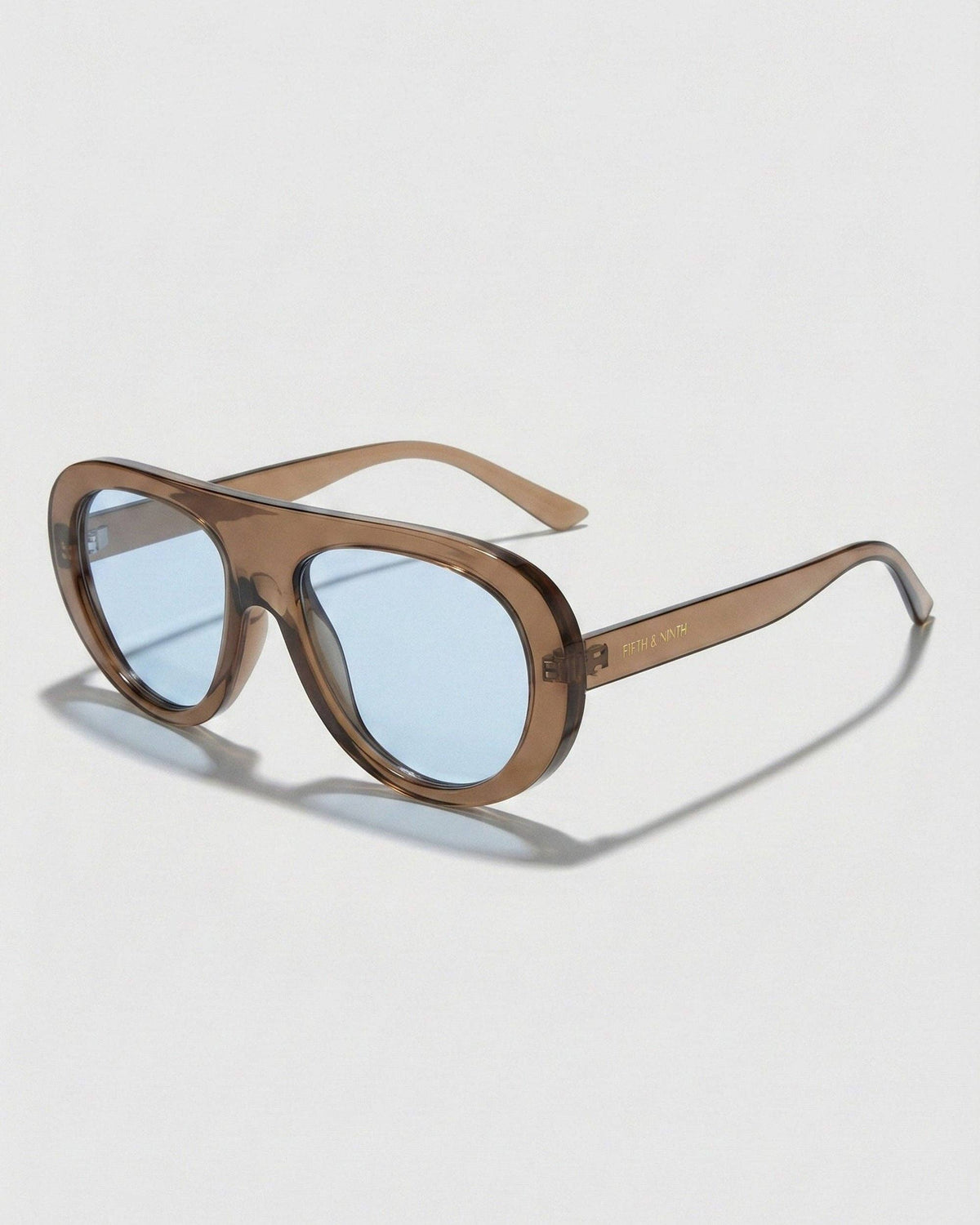 Side profile of Oceane brown and blue polarized aviator sunglasses highlighting the curved brown frame and rounded temple design.